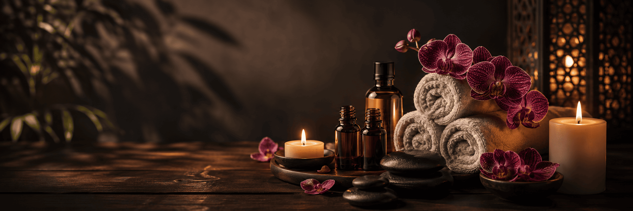 Massage stones, flowers and candles in a peaceful spa setting