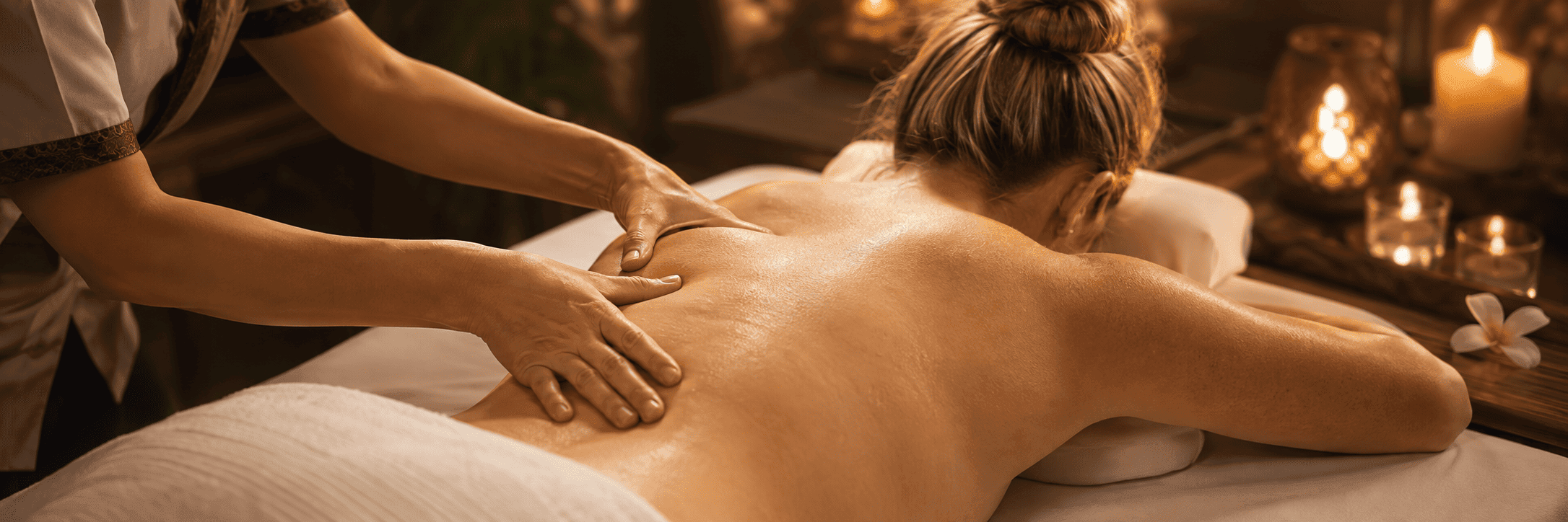 Traditional Thai massage treatment in a warm candlelit room